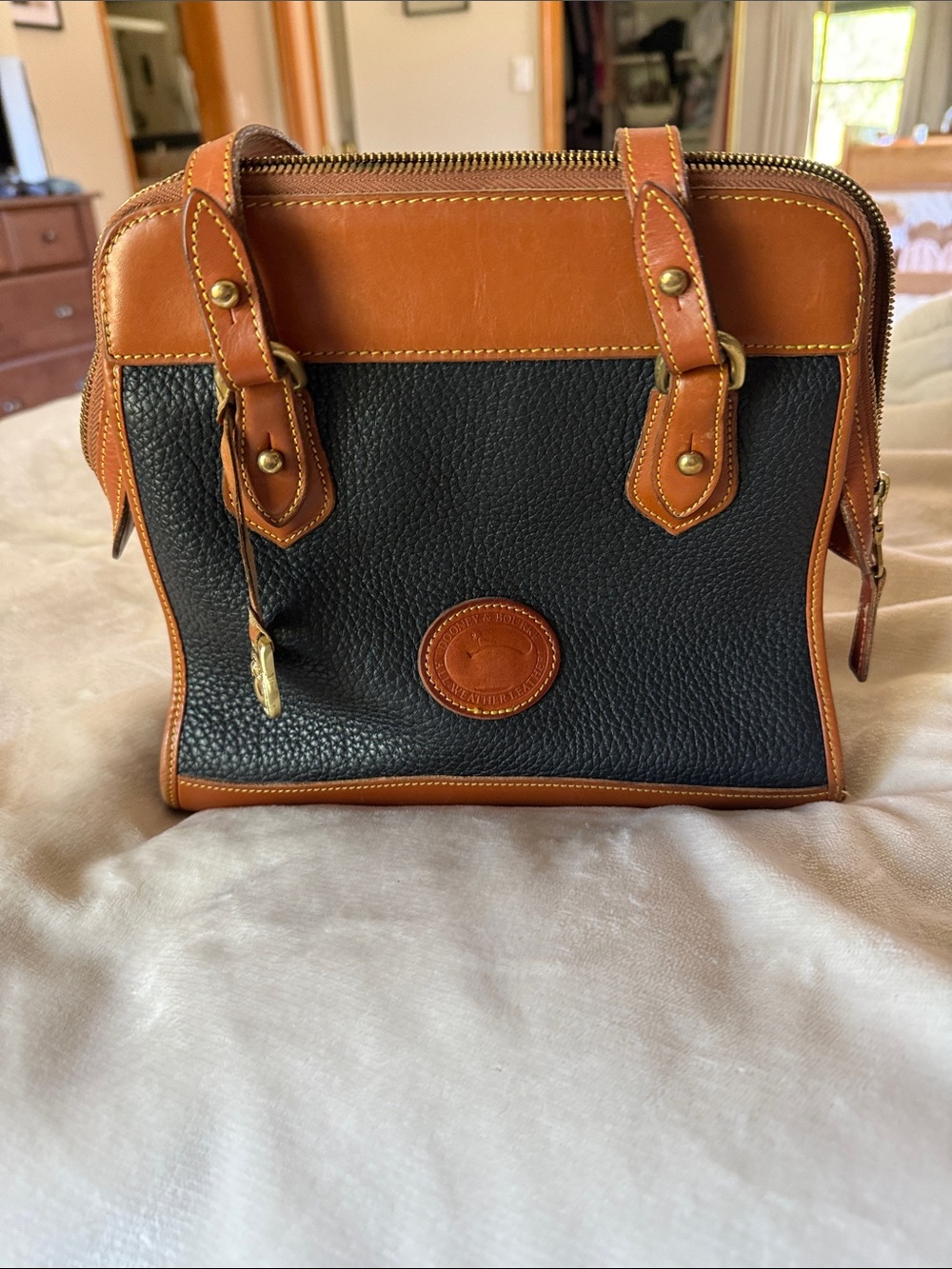 Dooney and Bourke Classic Black Pebbled Shoulder Bag with Tan Trim